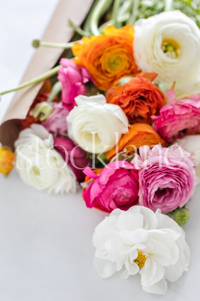 Vertical stock photo of a bouquet of ranunculus.