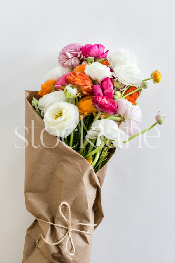 Vertical stock photo of a bouquet of ranunculus.