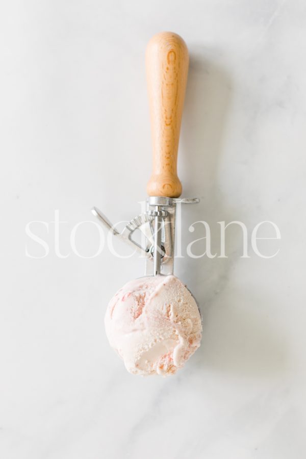 Vertical stock photo of a scoop of strawberry ice cream