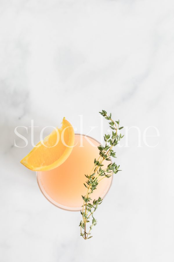 Vertical stock photo of a glass with citrus juice.