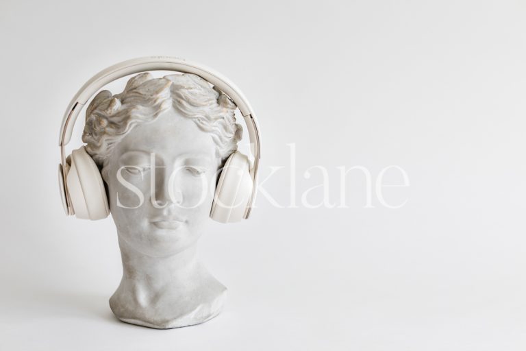 Horizontal stock photo of a woman head sculpture with headphones