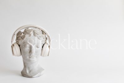 Horizontal stock photo of a woman head sculpture with headphones