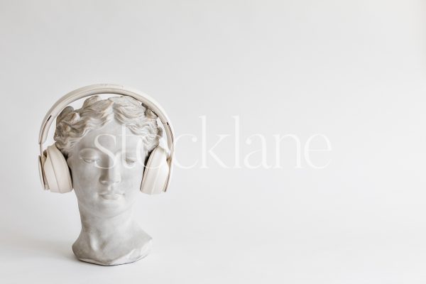 Horizontal stock photo of a woman head sculpture with headphones