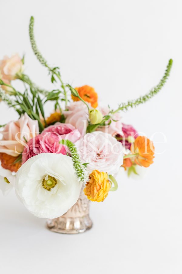 Vertical stock photo of a white and pink flower arrangement.