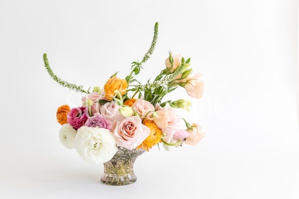 Horizontal stock photo of a white and pink flower arrangement.