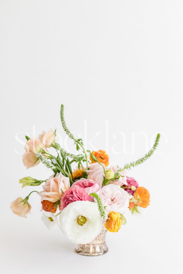 Vertical stock photo of a white and pink flower arrangement.