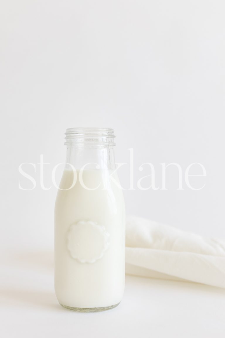 Vertical stock photo of a jar of milk.