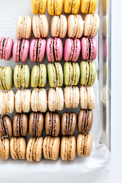 Vertical stock photo of a colorful tray of macarons.