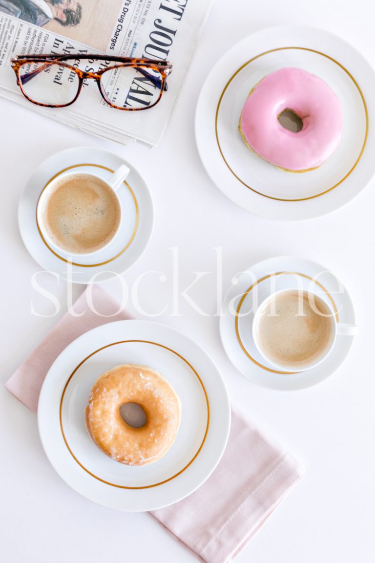 Vertical stock photo of donuts and coffee in blush pink.