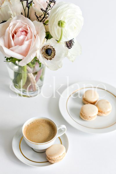 Vertical stock photo of coffee and macarons.