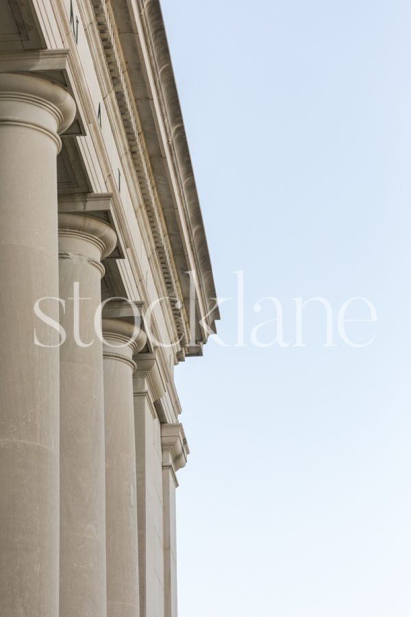 Vertical stock photo of a classic building with blue sky in the background.