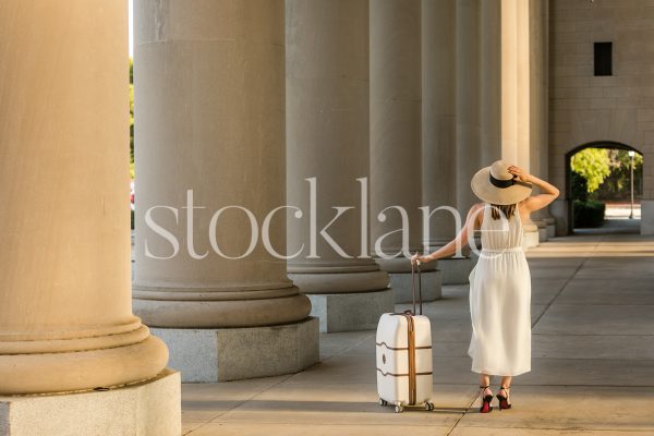 Horizontal stock photo of a woman with a suitcase.