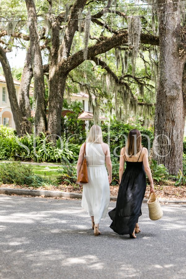 Vertical stock photo of two woman friends walking.