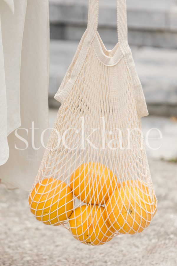 Vertical stock photo of a bag of grapefruits.