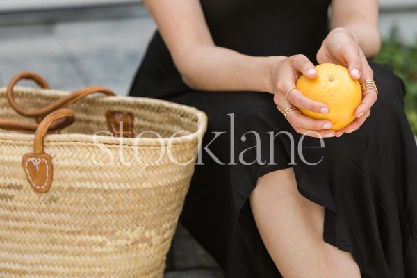 Horizontal Stock photo of a women with a bag and grapefruit