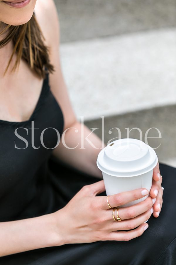 Vertical stock photo of a woman having a cup of coffee.