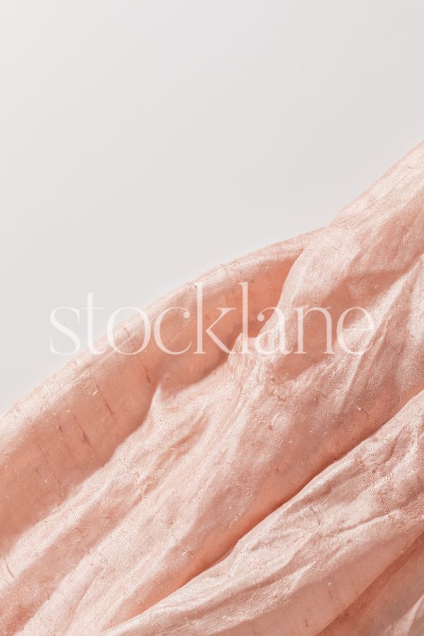 Vertical stock photo of a golden pink cloth.