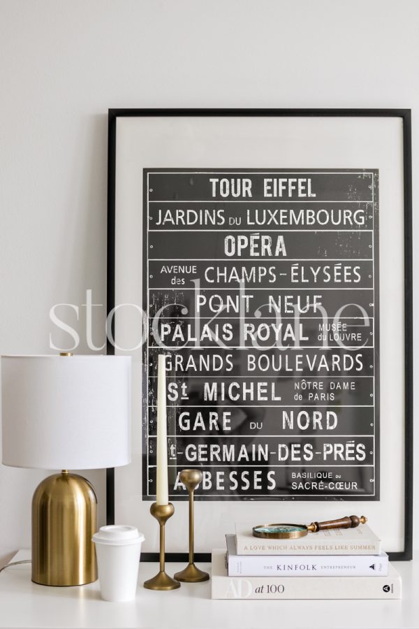 Vertical stock photo of a home decor vignette in neutral and black colors.