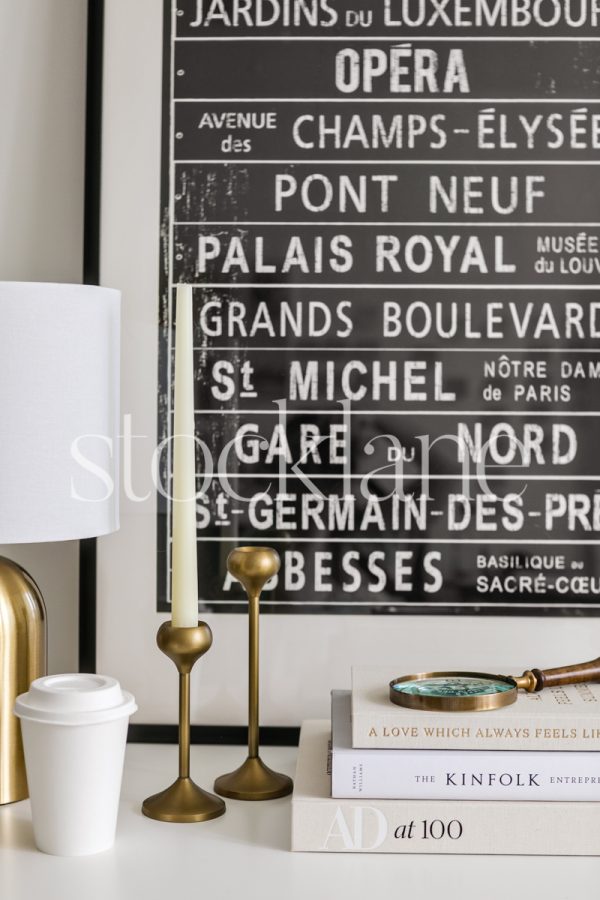 Vertical stock photo of a home decor vignette in neutral and black colors.