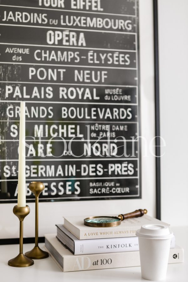 Vertical stock photo of a home decor vignette in neutral and black colors.