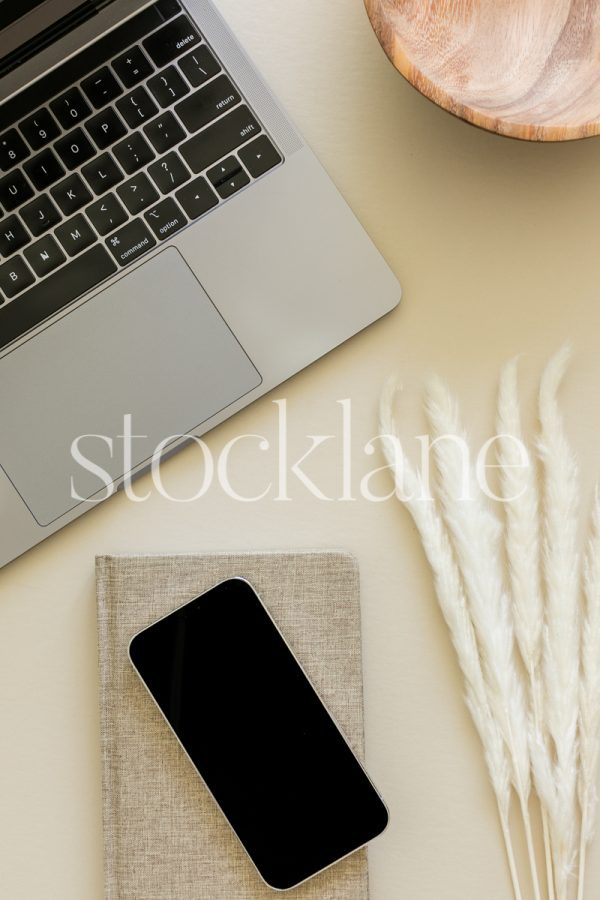 Vertical stock photo of a laptop computer with fall-themed decor.