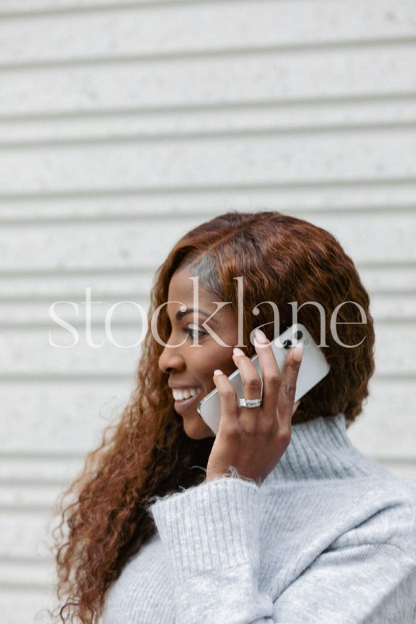 Vertical stock photo of a woman talking on the phone.