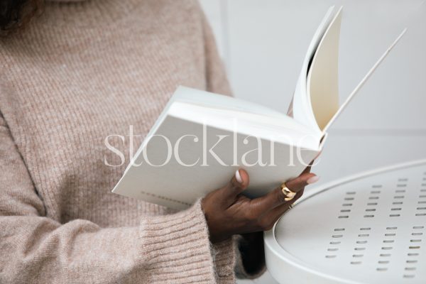 Horizontal stock photo of a woman reading a book.