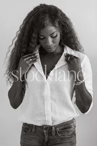 Vertical black and white photo of a woman wearing a white shirt.