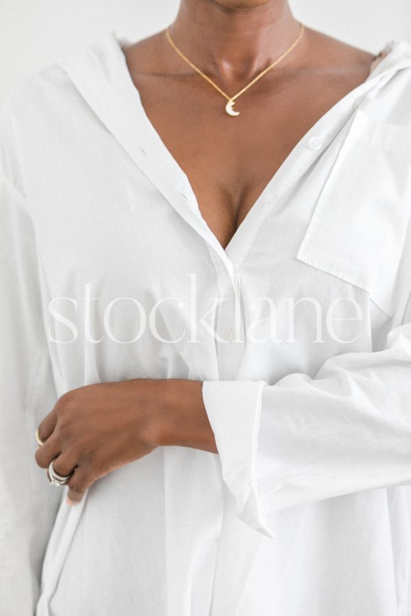 Vertical stock photo of a woman wearing a white shirt.