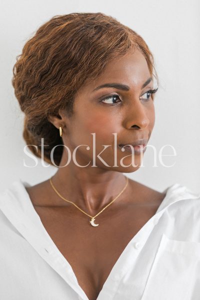 Vertical stock photo of a woman wearing a white shirt.