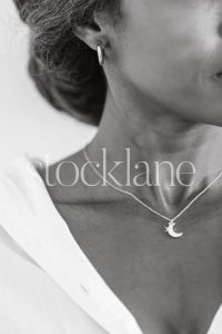 Vertical black and white stock photo of a woman's profile.