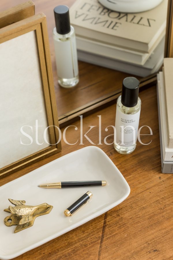 Vertical stock photo of a wood table with an assortment of neutral colored things.