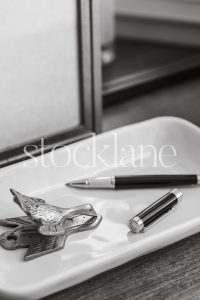 Vertical black and white stock photo of desk items.