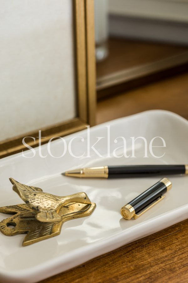 Vertical stock photo of desk items in neutral colors.