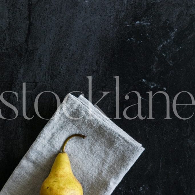 Vertical stock photo of pear in dark background