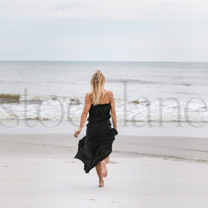 Vertical stock photo of woman at the beach